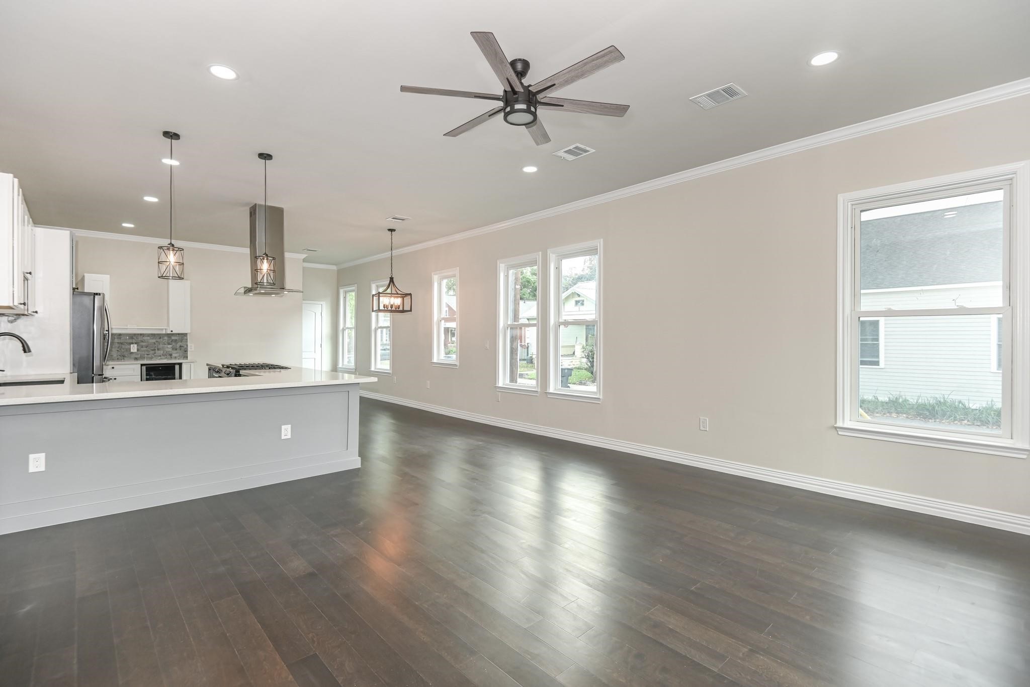 2902 Houston Avenue Houston, TX 77009 - Photo 13 of 42 a view of an empty room with window and wooden floor