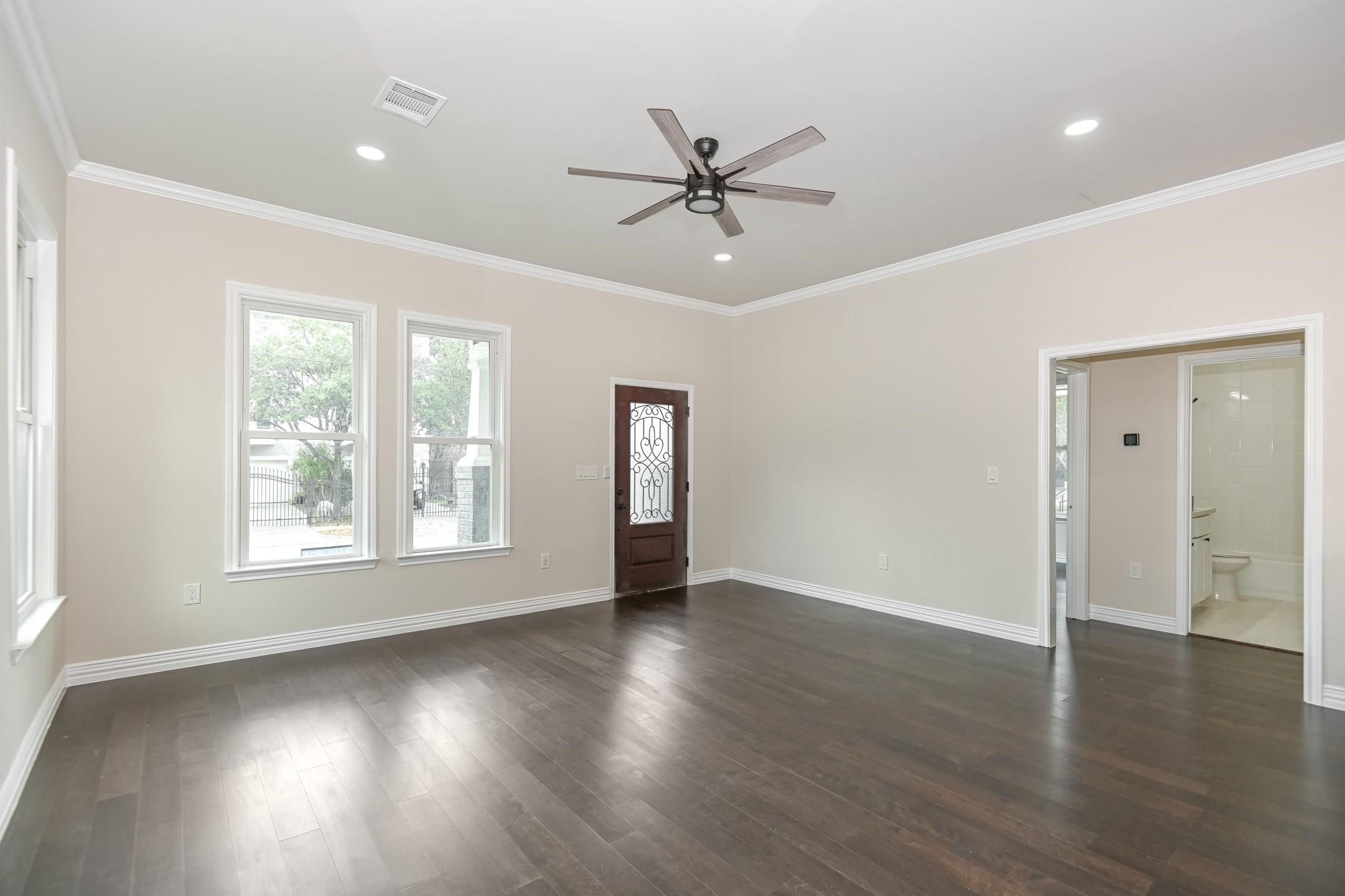 2902 Houston Avenue Houston, TX 77009 - Photo 15 of 42 a view of an empty room with wooden floor and a window