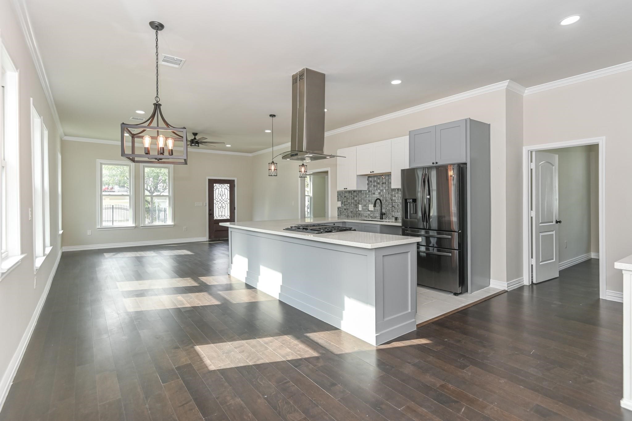 2902 Houston Avenue Houston, TX 77009 - Photo 16 of 42 a view of a kitchen with stainless steel appliances granite countertop a stove a refrigerator and a wooden floors