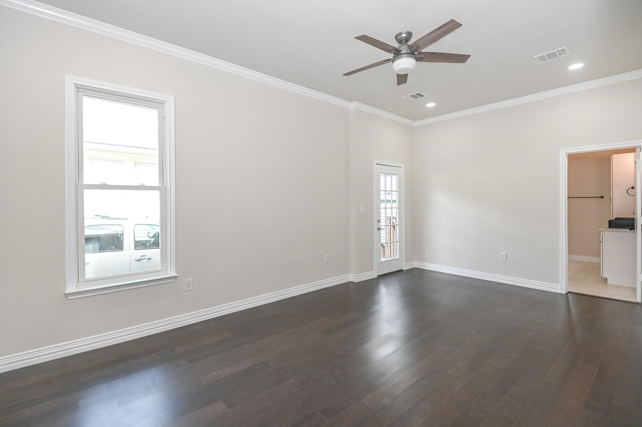 2902 Houston Avenue Houston, TX 77009 - Photo 18 of 42 an empty room with wooden floor and windows