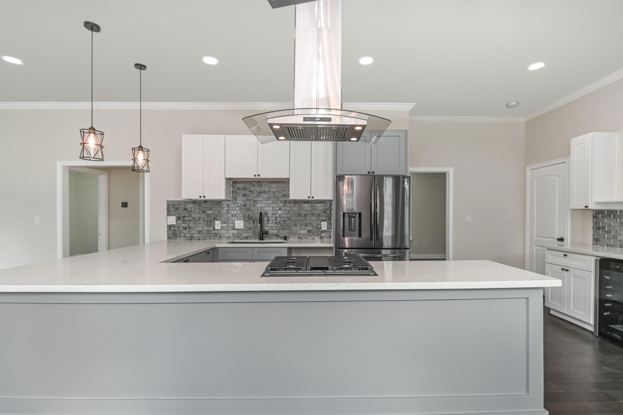 2902 Houston Avenue Houston, TX 77009 - Photo 20 of 42 a kitchen with stainless steel appliances kitchen island granite countertop a sink a stove and a refrigerator