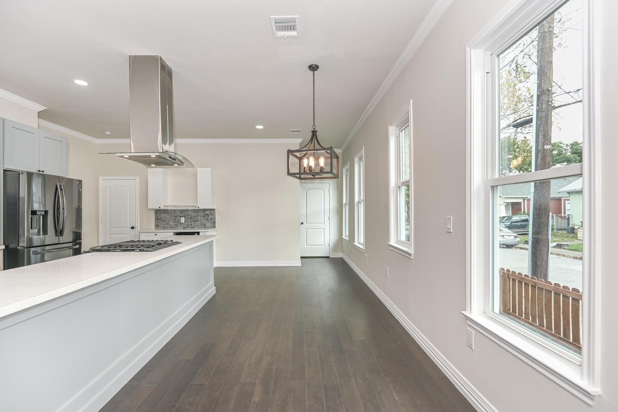 2902 Houston Avenue Houston, TX 77009 - Photo 26 of 42 a view of a kitchen with a sink wooden floor and a window