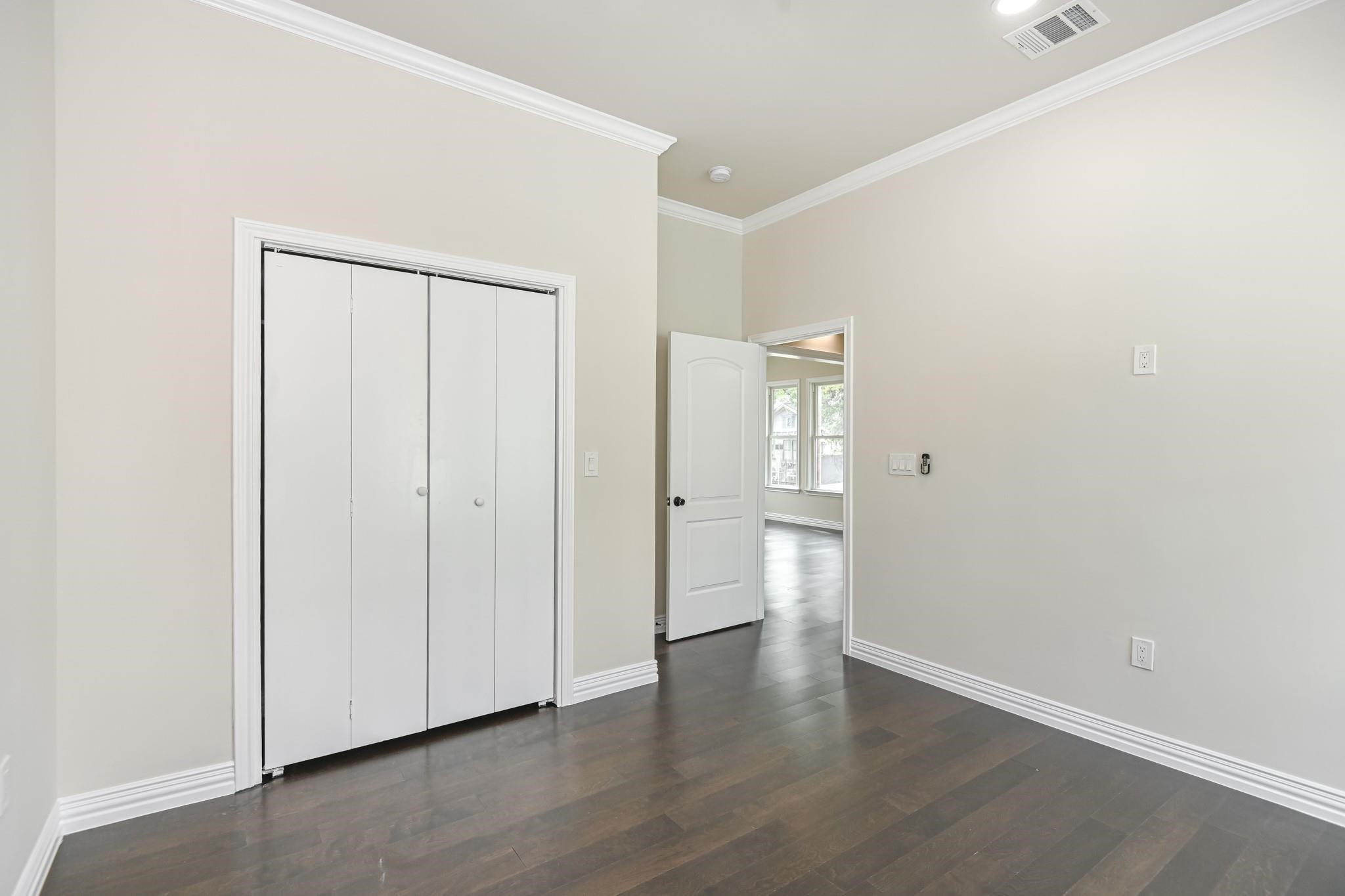 2902 Houston Avenue Houston, TX 77009 - Photo 34 of 42 an empty room with wooden floor and closet area