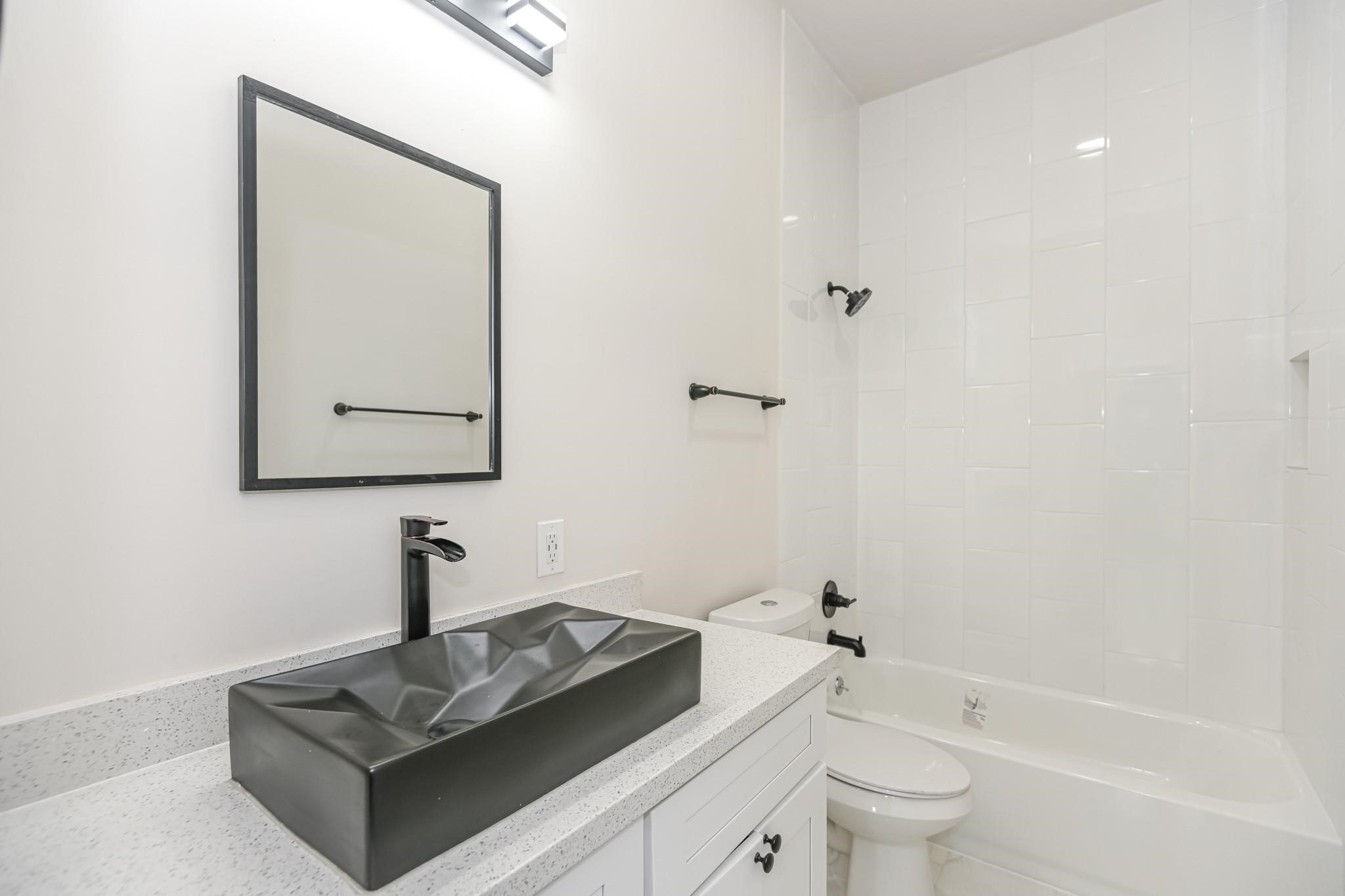 2902 Houston Avenue Houston, TX 77009 - Photo 35 of 42 a bathroom with a toilet sink and mirror
