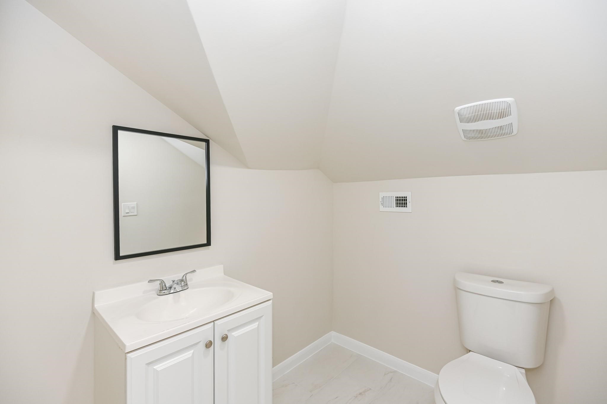 2902 Houston Avenue Houston, TX 77009 - Photo 40 of 42 a bathroom with a toilet sink and mirror
