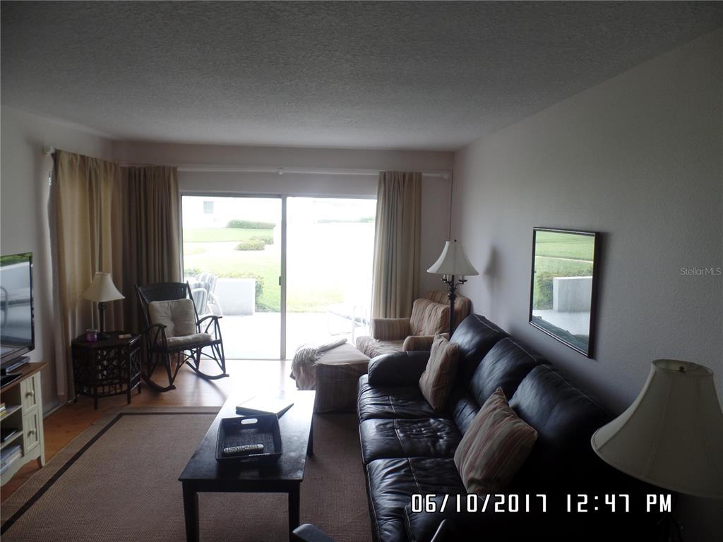 815 Ocean Shore Boulevard, Unit 11 Ormond Beach, FL 32176 - Photo 11 of 15 a living room with furniture