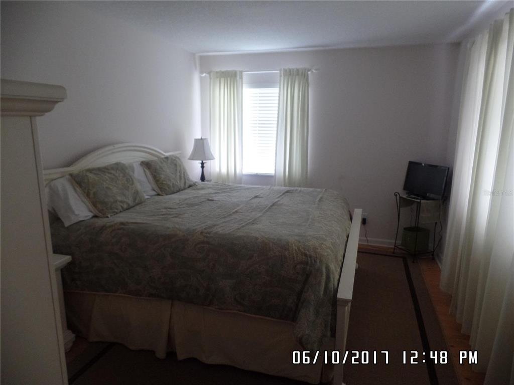 815 Ocean Shore Boulevard, Unit 11 Ormond Beach, FL 32176 - Photo 14 of 15 a bedroom with a bed and a window