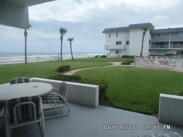 a view of a patio with furniture and a yard