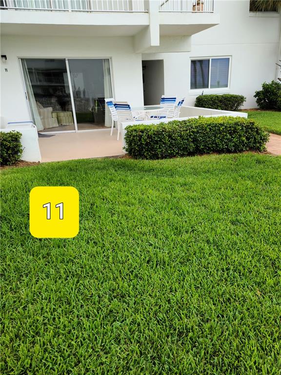 815 Ocean Shore Boulevard, Unit 11 Ormond Beach, FL 32176 - Photo 4 of 15 a view of a house with a backyard space