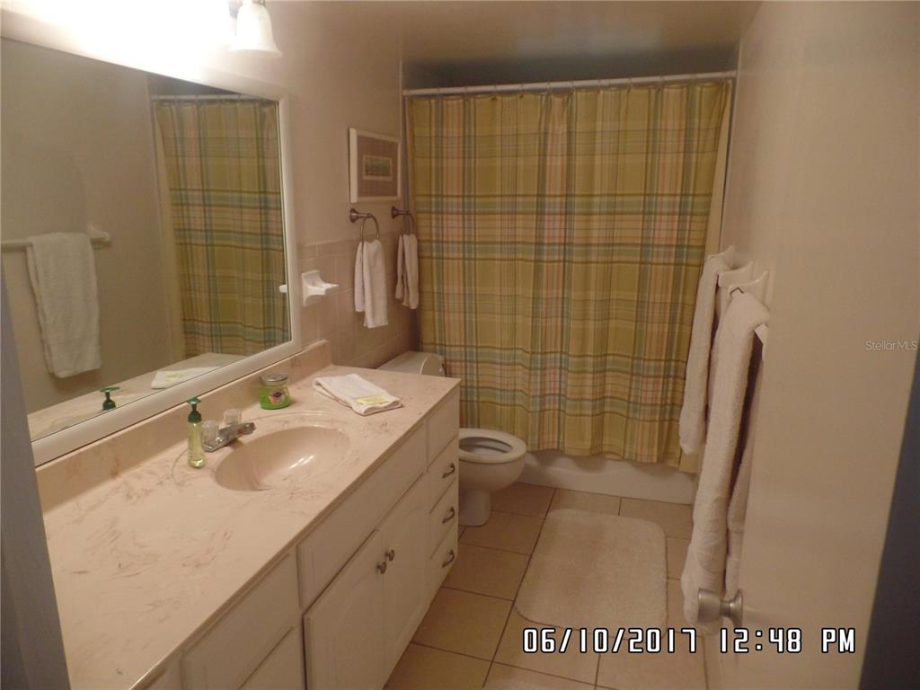 815 Ocean Shore Boulevard, Unit 11 Ormond Beach, FL 32176 - Photo 5 of 15 a bathroom with a sink a toilet and shower