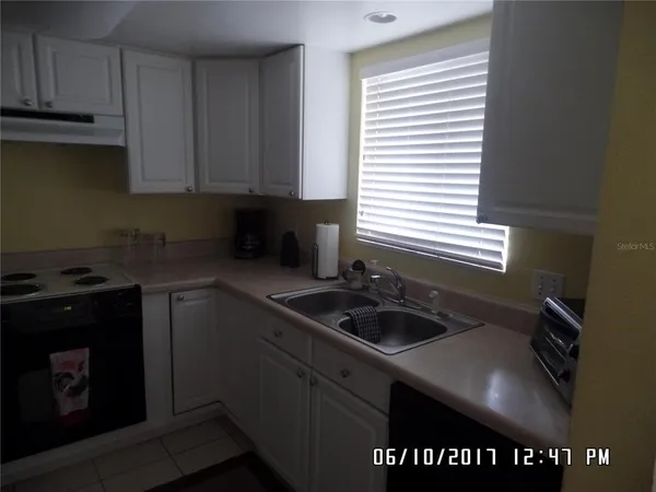 a kitchen with a sink cabinets and window