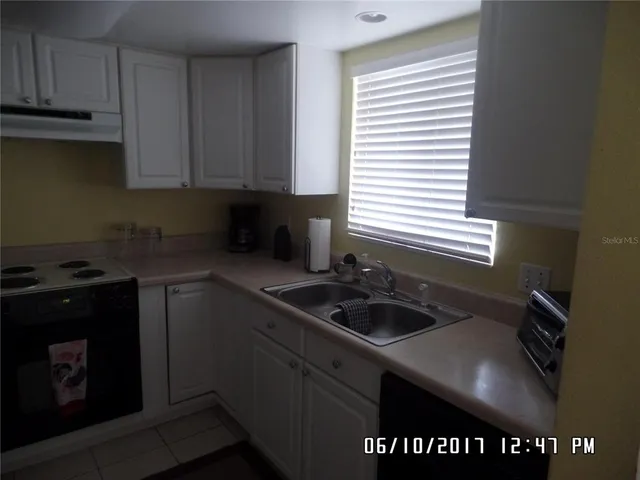 a kitchen with a sink cabinets and window