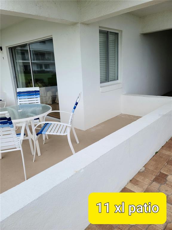 815 Ocean Shore Boulevard, Unit 11 Ormond Beach, FL 32176 - Photo 9 of 15 a view of a kitchen with furniture and window
