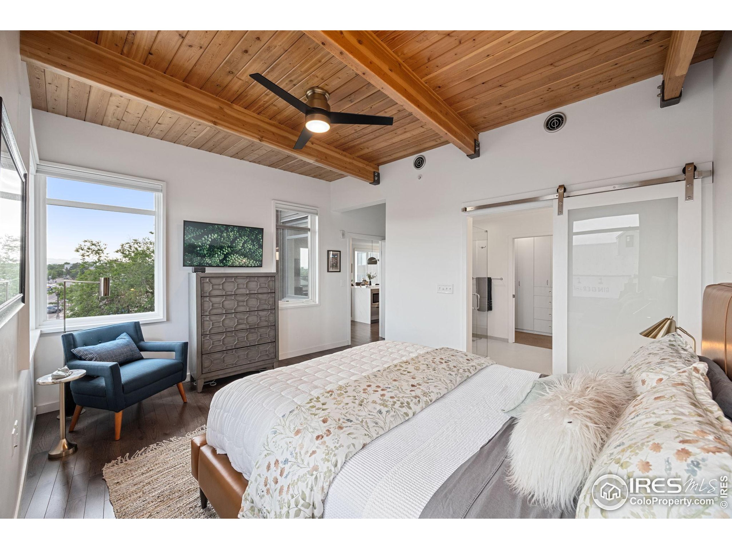 401 Linden Street, Unit 307 Fort Collins, CO 80524 - Photo 14 of 47 a bedroom with a large bed and a balcony