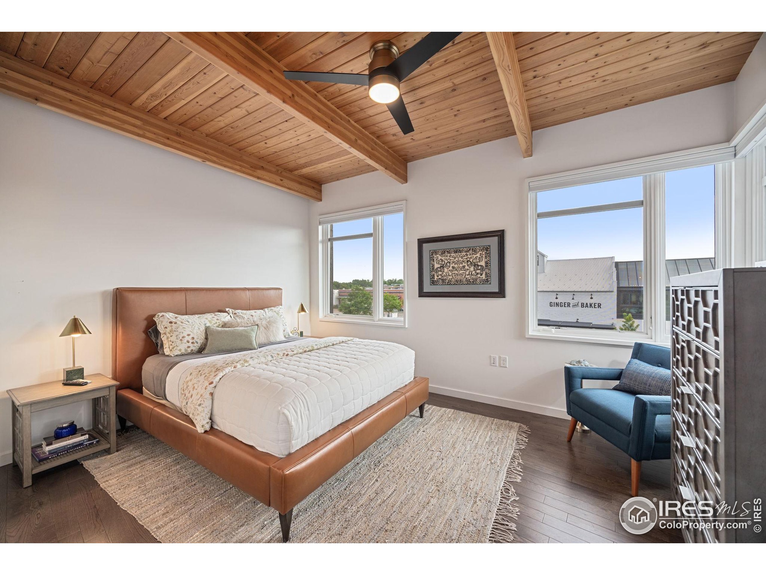 401 Linden Street, Unit 307 Fort Collins, CO 80524 - Photo 15 of 47 a bedroom with a large bed couch and a window