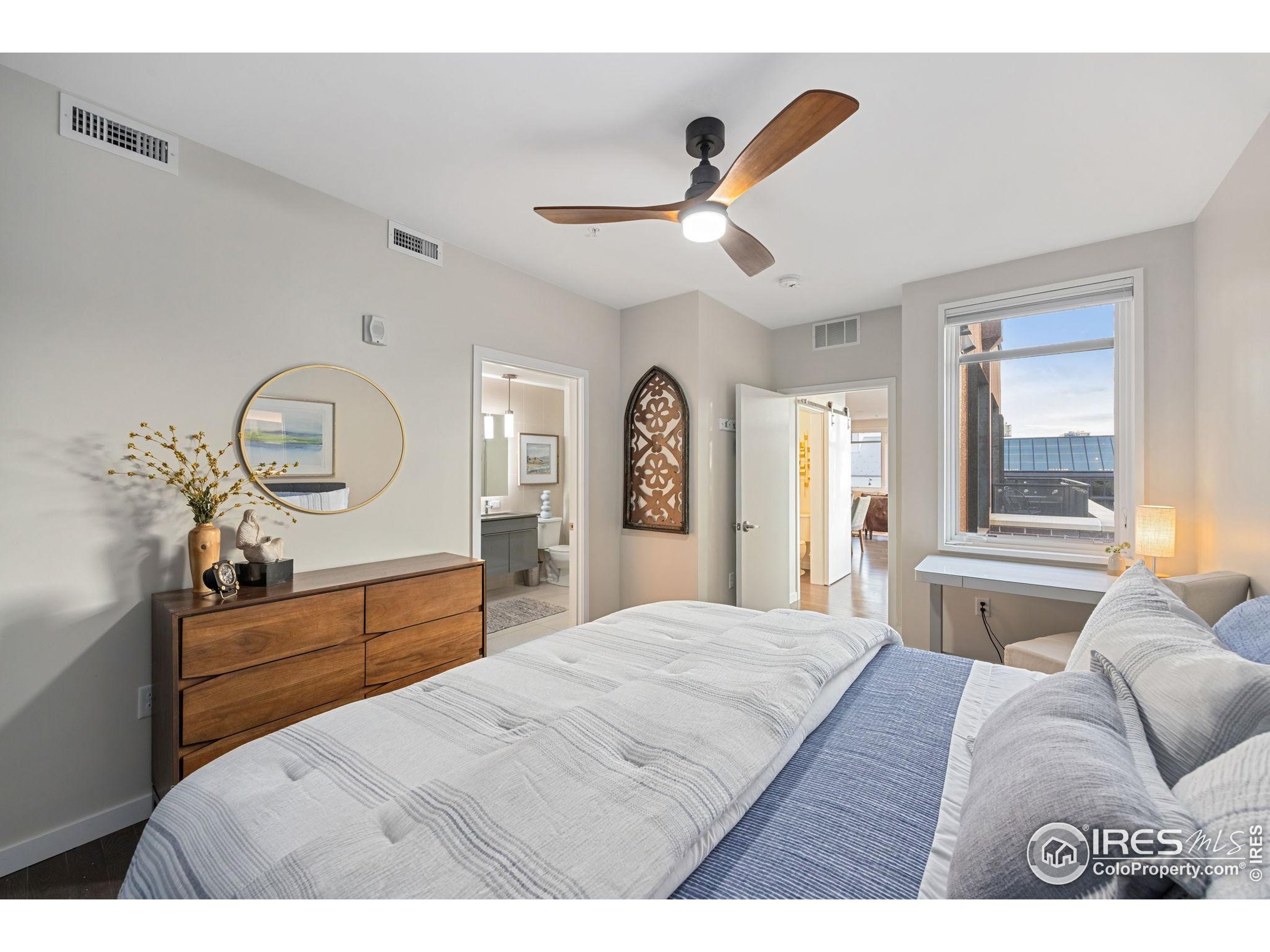 401 Linden Street, Unit 307 Fort Collins, CO 80524 - Photo 22 of 47 a bedroom with a large bed and a dresser