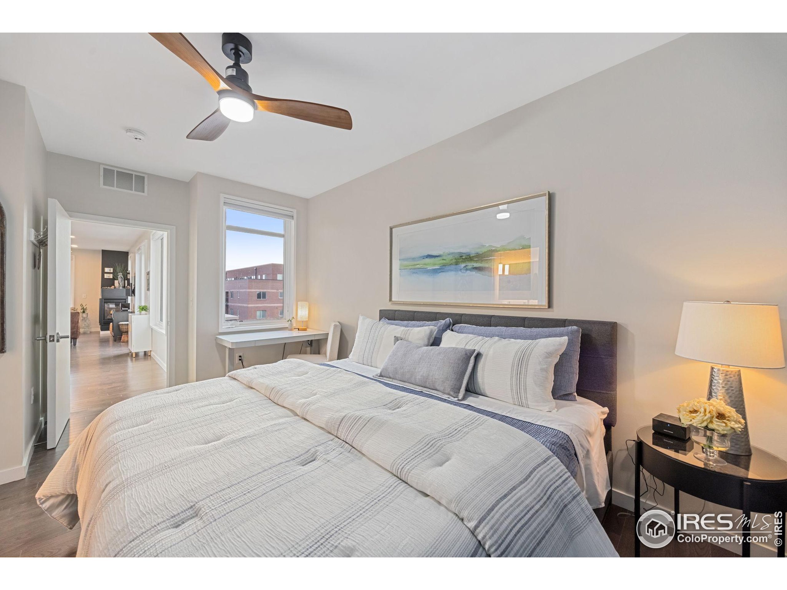 401 Linden Street, Unit 307 Fort Collins, CO 80524 - Photo 23 of 47 a bedroom with a bed and a painting on the wall