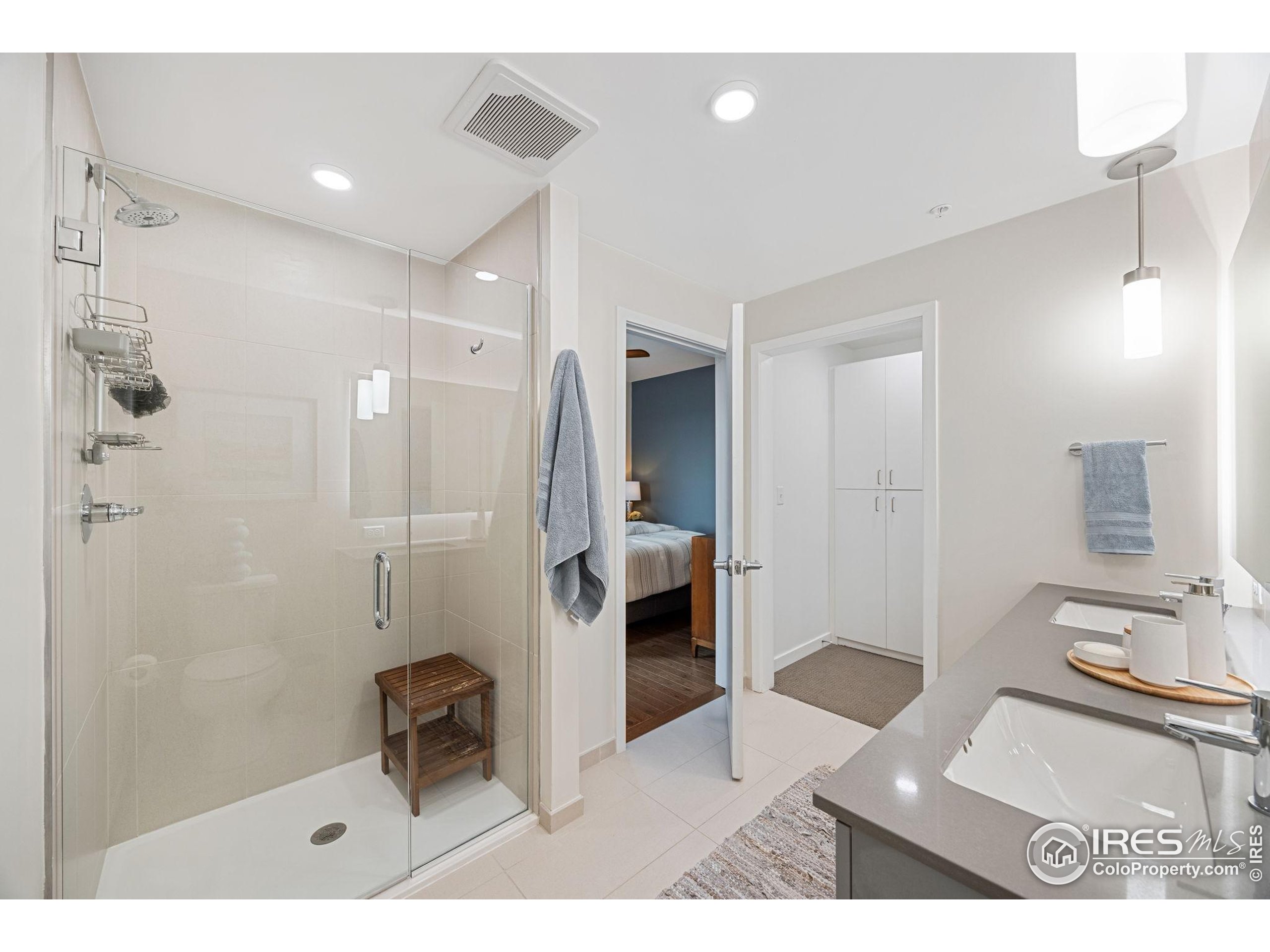 401 Linden Street, Unit 307 Fort Collins, CO 80524 - Photo 26 of 47 a bathroom with a sink a toilet a mirror and shower