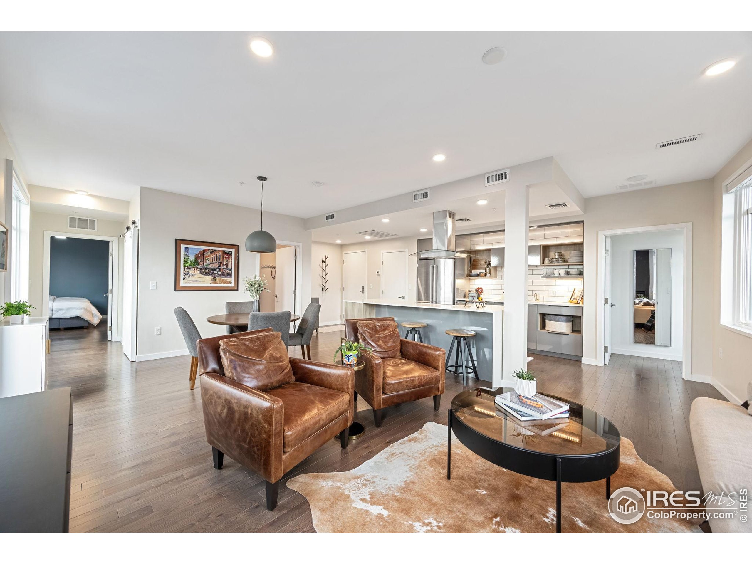 401 Linden Street, Unit 307 Fort Collins, CO 80524 - Photo 5 of 47 a living room with furniture and wooden floor