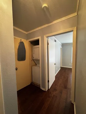 a view of a hallway with wooden floor and closet