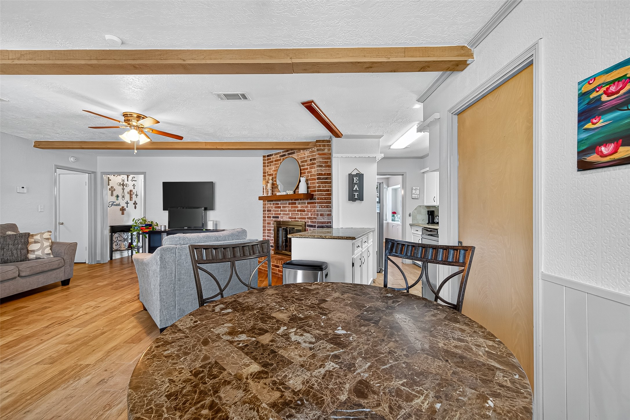 14415 Wadebridge Way Houston, TX 77015 - Photo 19 of 41 a living room with furniture a flat screen tv and kitchen view