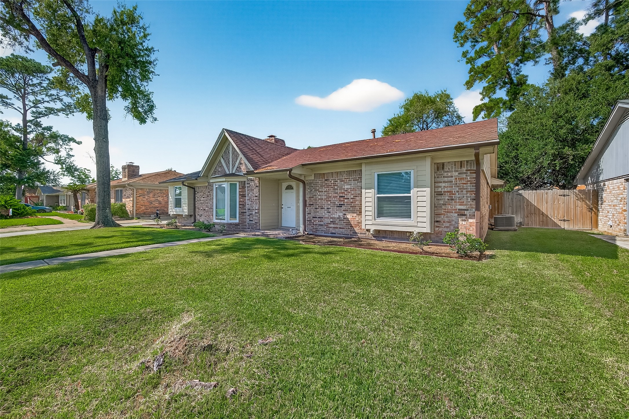 14415 Wadebridge Way Houston, TX 77015 - Photo 2 of 41 a view of a yard in front of a house with large tree