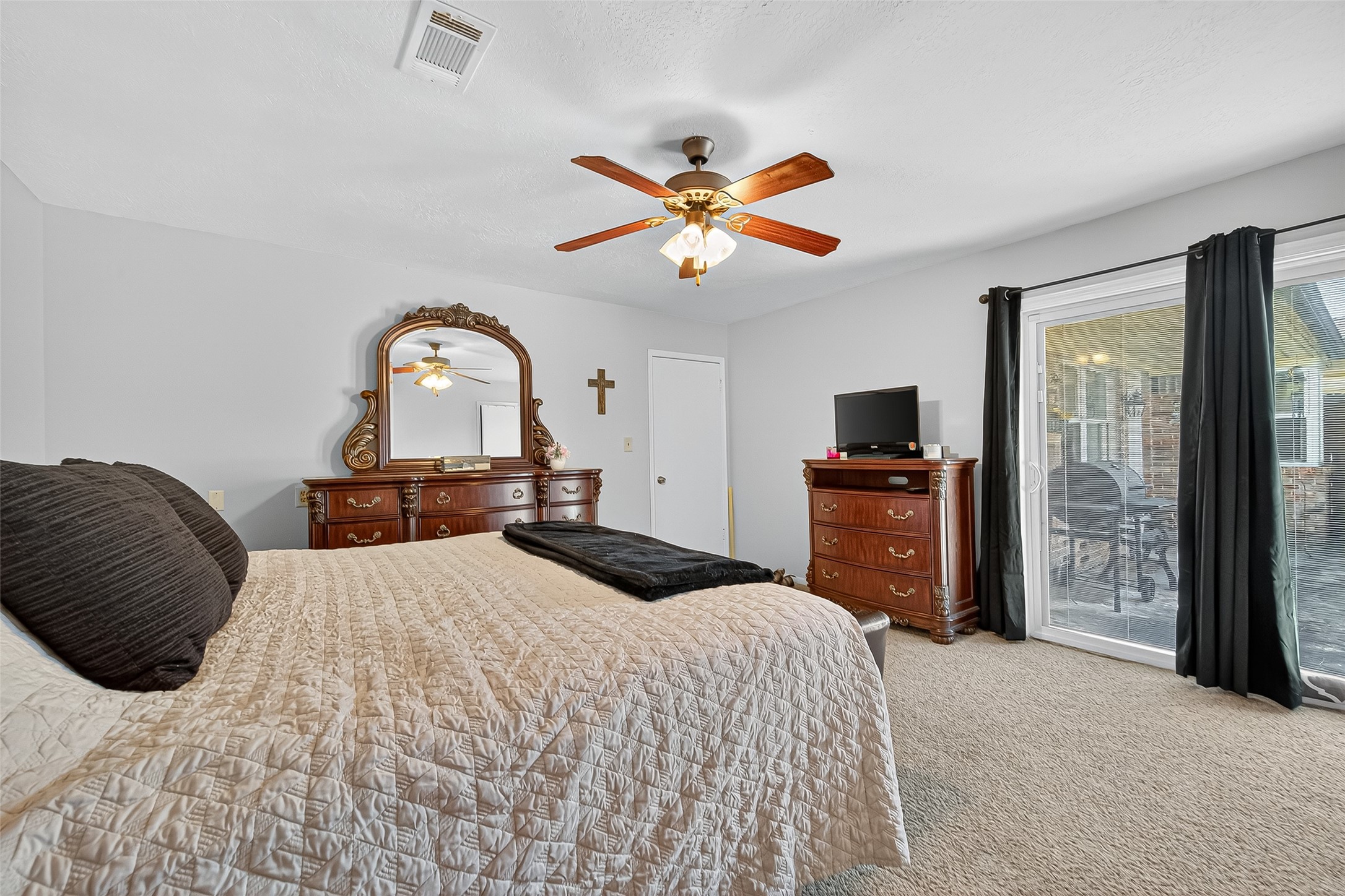 14415 Wadebridge Way Houston, TX 77015 - Photo 30 of 41 a bedroom with a bed and a chandelier