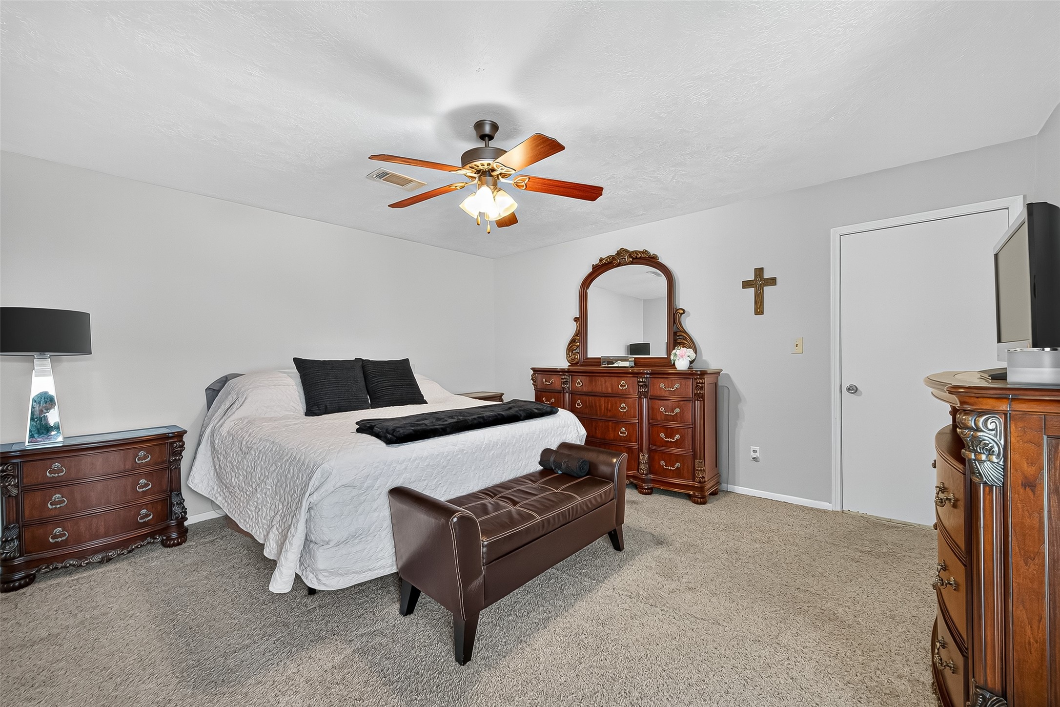 14415 Wadebridge Way Houston, TX 77015 - Photo 32 of 41 a bedroom with bed and a chandelier