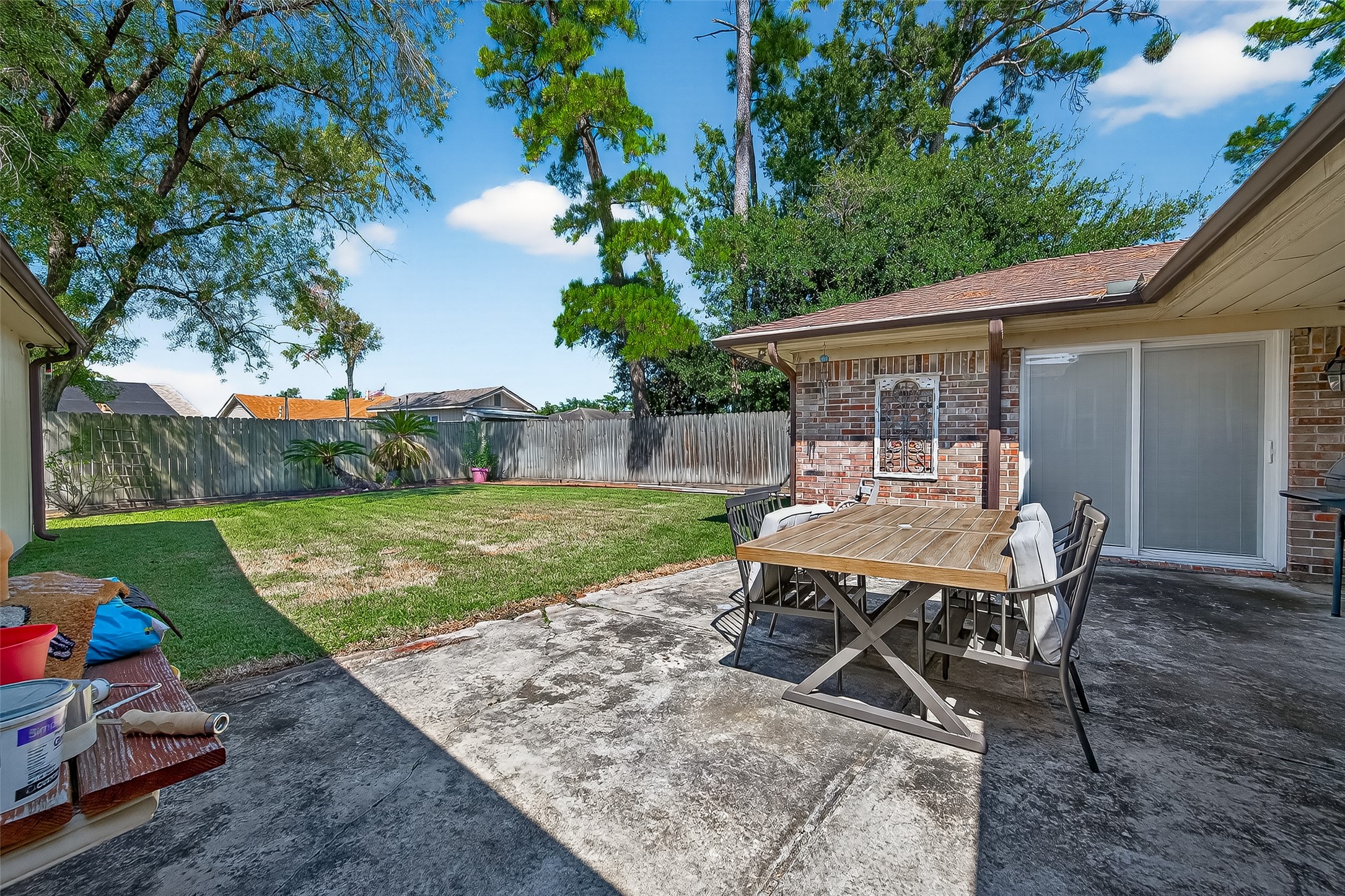 14415 Wadebridge Way Houston, TX 77015 - Photo 35 of 41 a view of a backyard with table and chairs potted plants and a large tree