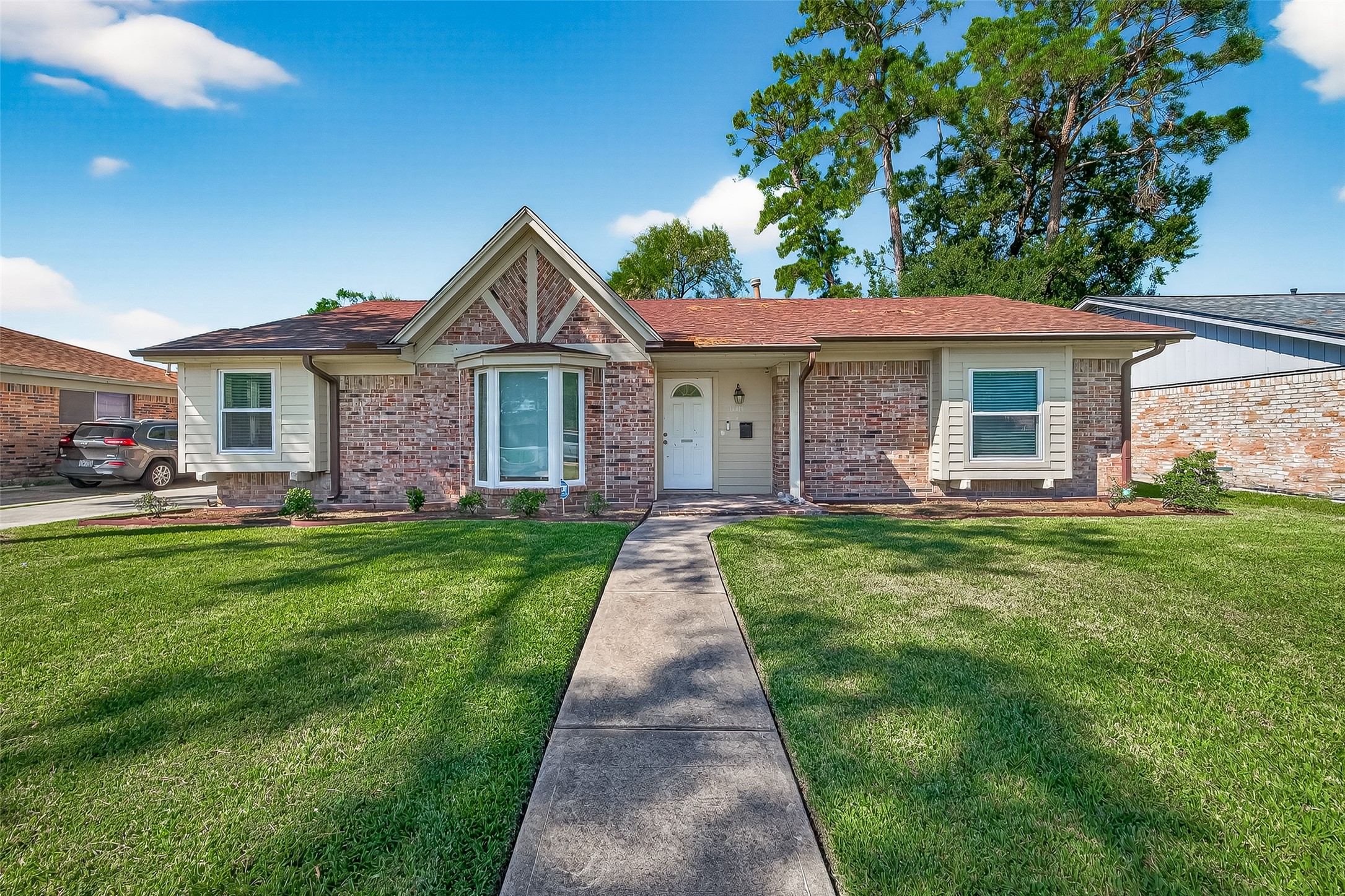14415 Wadebridge Way Houston, TX 77015 - Photo 4 of 41 a front view of a house with a garden and yard