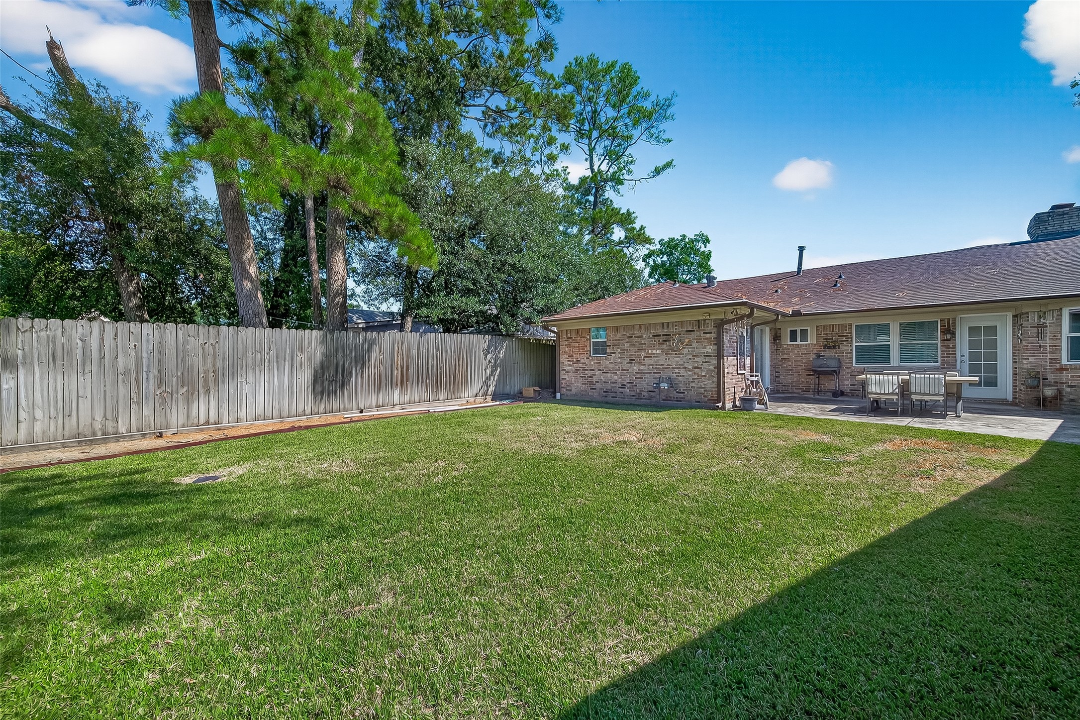 14415 Wadebridge Way Houston, TX 77015 - Photo 41 of 41 a view of a house with a backyard and a patio