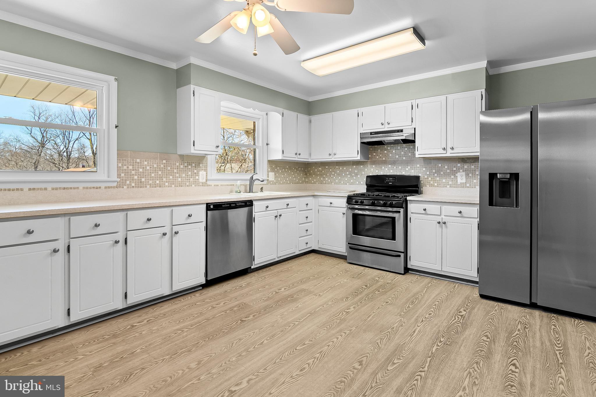 13 Moray Court Baltimore, MD 21236 - Photo 10 of 55 a kitchen with white cabinets stainless steel appliances and a window