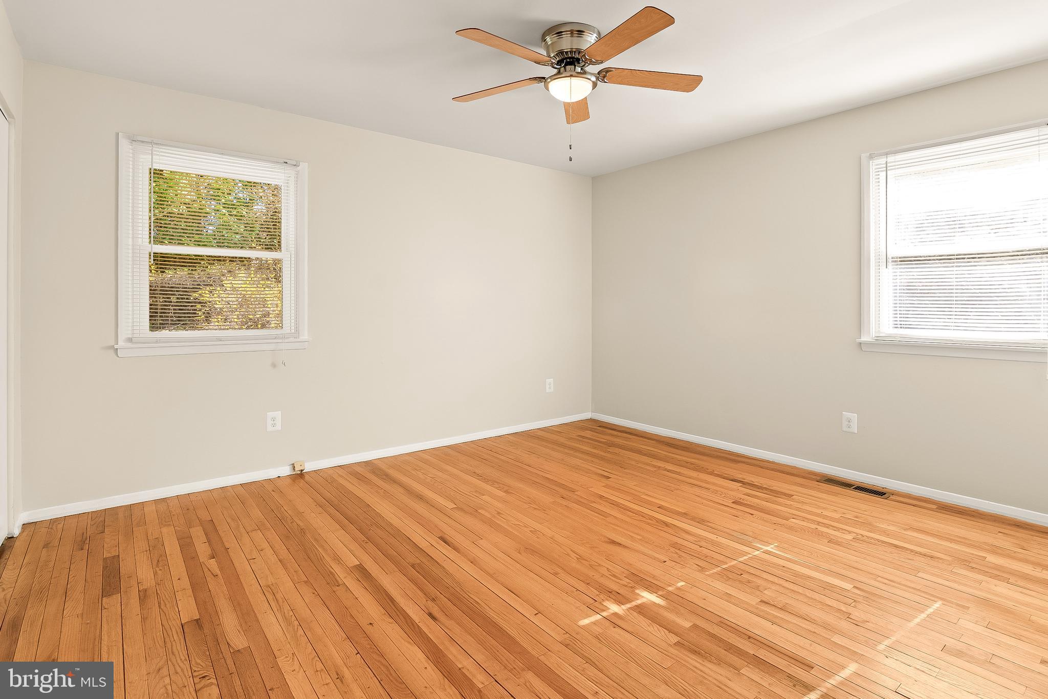 13 Moray Court Baltimore, MD 21236 - Photo 18 of 55 a view of an empty room with wooden floor and a window