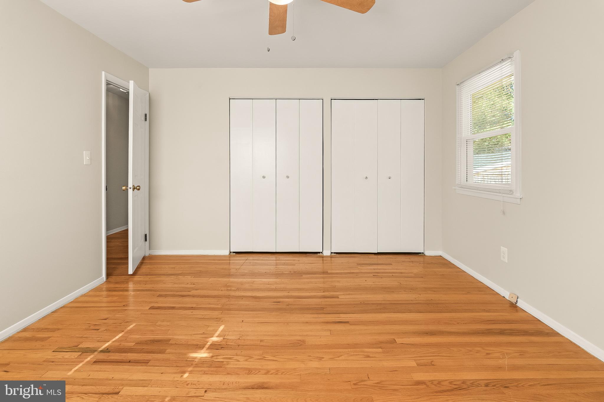 13 Moray Court Baltimore, MD 21236 - Photo 20 of 55 a view of an empty room with wooden floor and a window