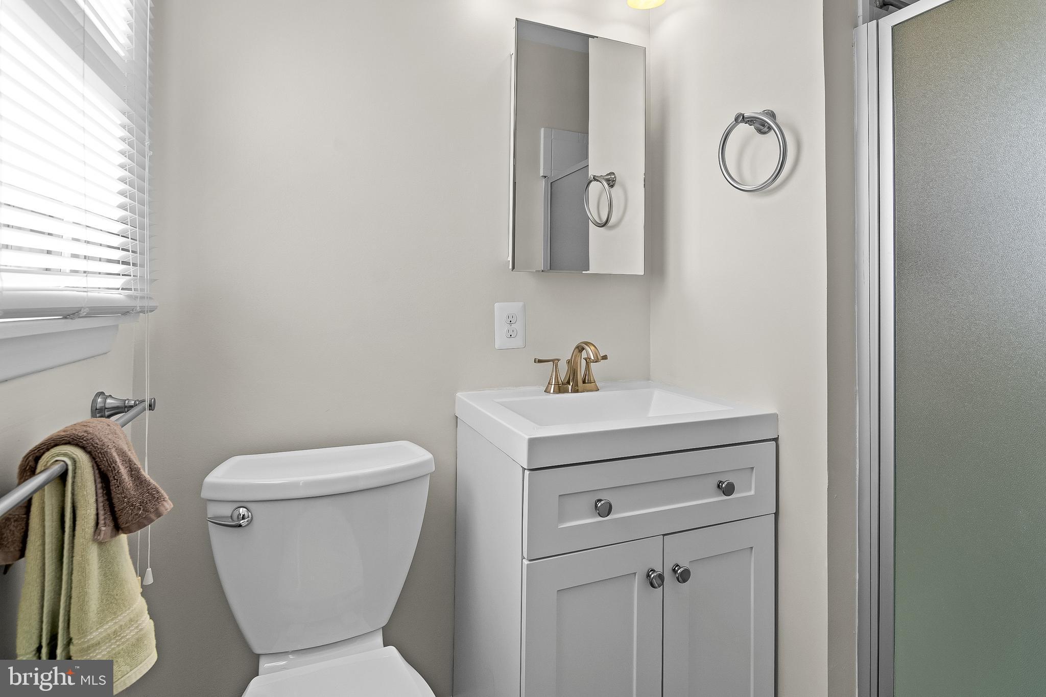 13 Moray Court Baltimore, MD 21236 - Photo 22 of 55 a bathroom with a toilet sink and mirror