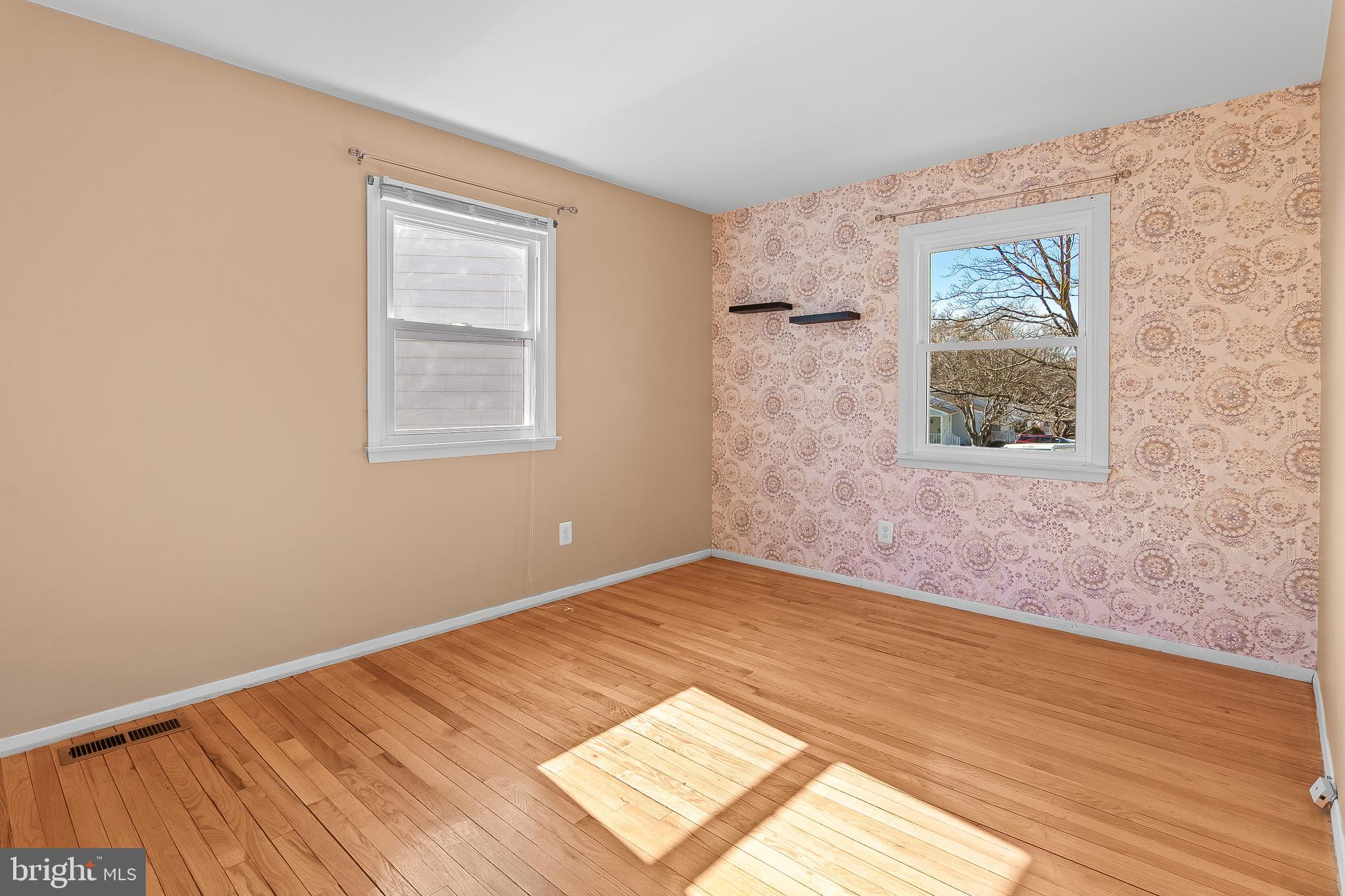 13 Moray Court Baltimore, MD 21236 - Photo 24 of 55 a view of an empty room with wooden floor and a window