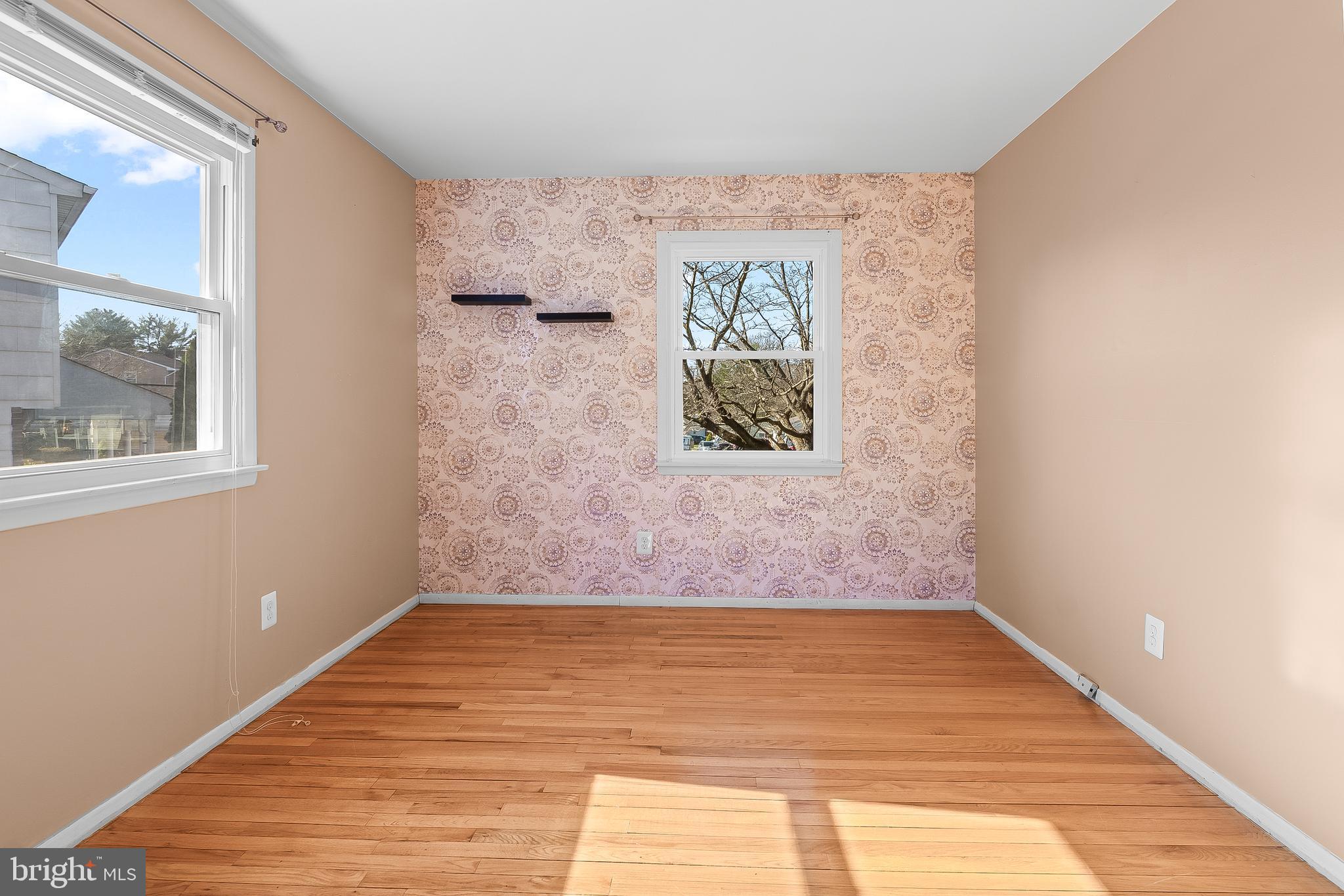 13 Moray Court Baltimore, MD 21236 - Photo 25 of 55 a view of an empty room with wooden floor and a window