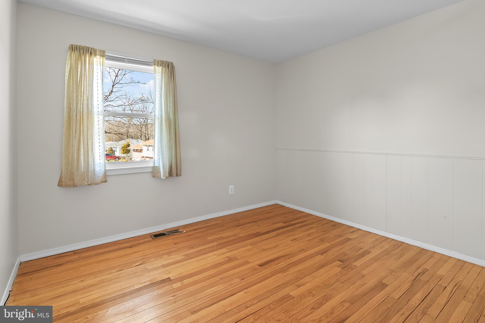13 Moray Court Baltimore, MD 21236 - Photo 27 of 55 a view of empty room with wooden floor and fan