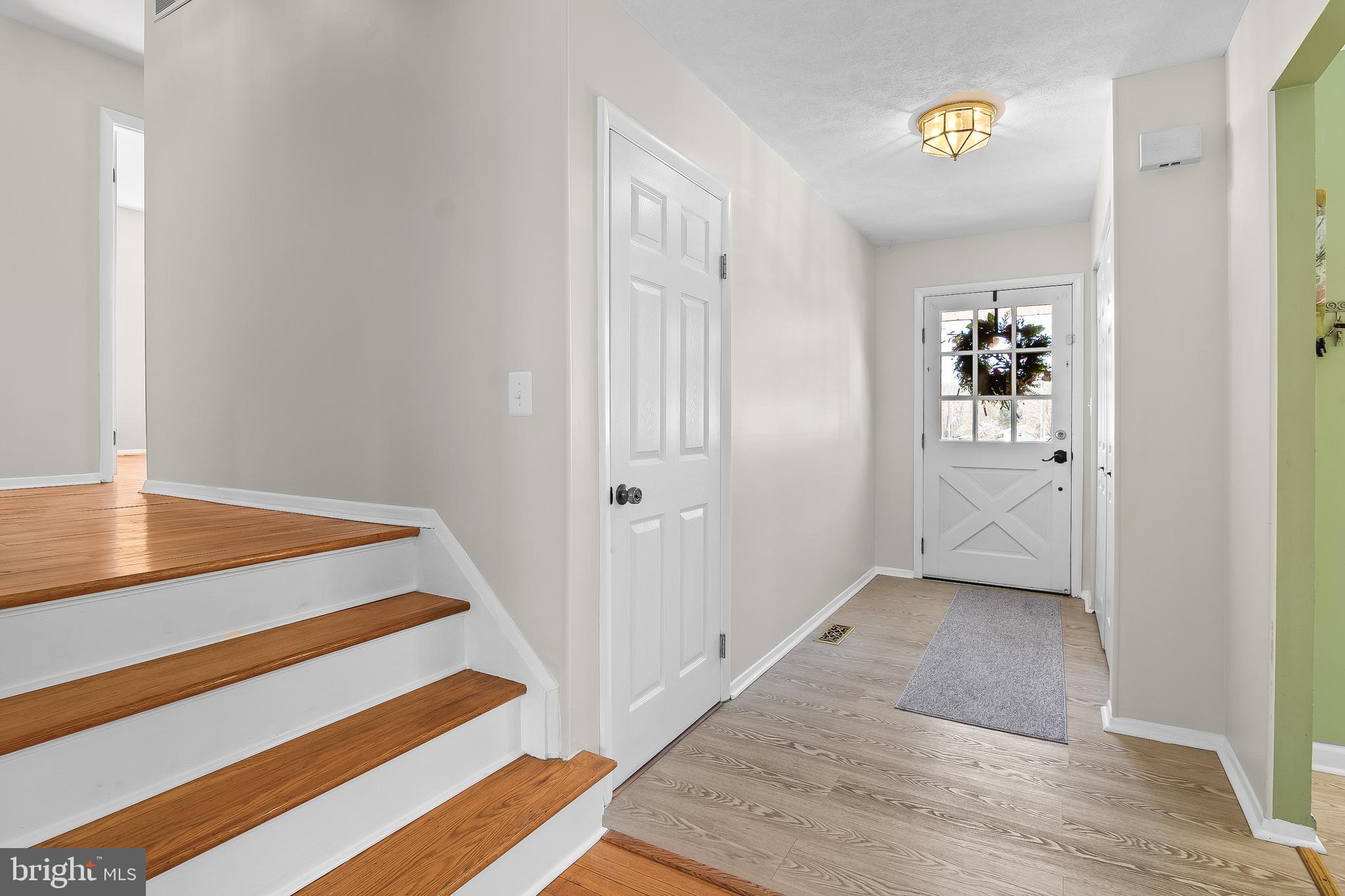 13 Moray Court Baltimore, MD 21236 - Photo 54 of 55 a view of a hallway with wooden floor and cabinet