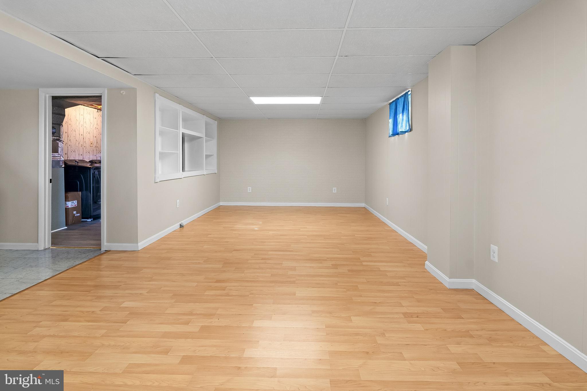 13 Moray Court Baltimore, MD 21236 - Photo 29 of 55 a view of empty room with wooden floor and fan