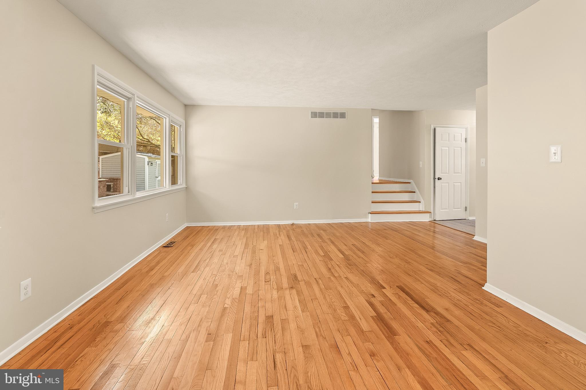 13 Moray Court Baltimore, MD 21236 - Photo 4 of 55 an empty room with wooden floor and windows