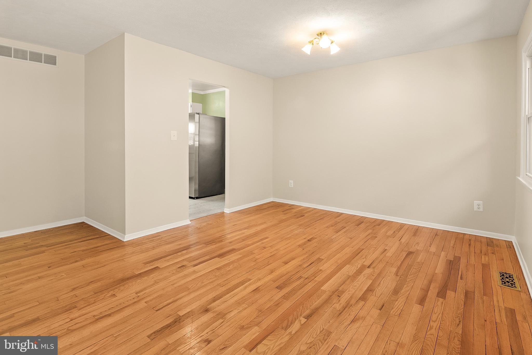 13 Moray Court Baltimore, MD 21236 - Photo 5 of 55 a view of empty room with wooden floor