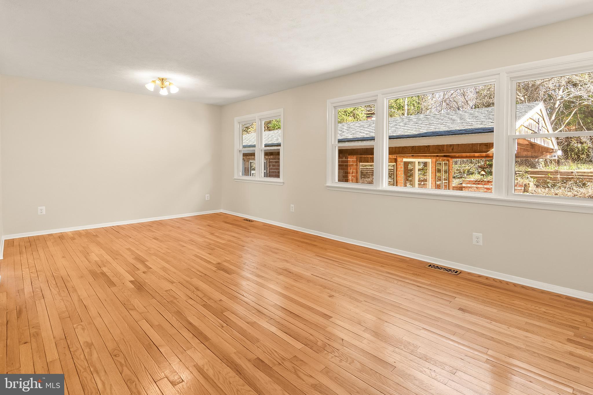 13 Moray Court Baltimore, MD 21236 - Photo 7 of 55 a view of an empty room with wooden floor and a window