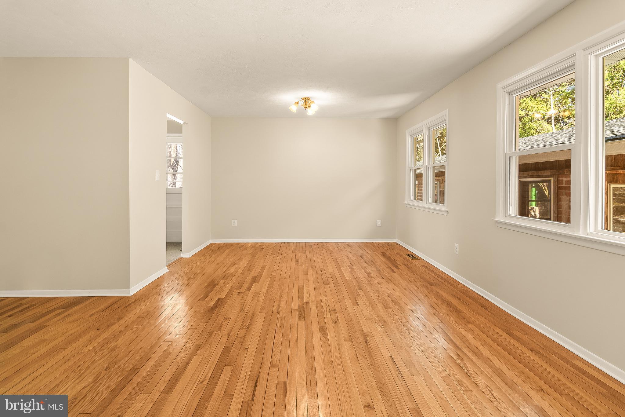 13 Moray Court Baltimore, MD 21236 - Photo 8 of 55 a view of empty room with wooden floor and fan