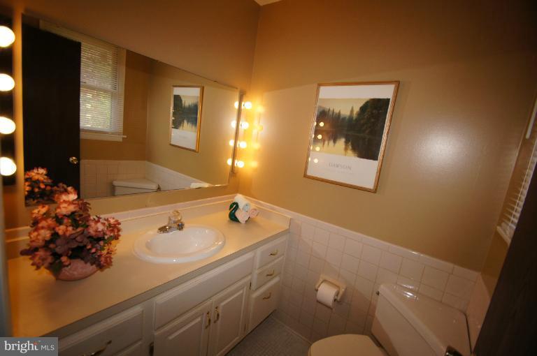 9504 Dundawan Road Nottingham, MD 21236 - Photo 2 of 30 a bathroom with a sink mirror and vanity