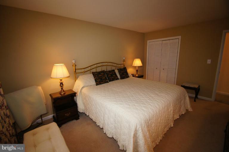 9504 Dundawan Road Nottingham, MD 21236 - Photo 14 of 30 a bedroom with a bed and a lamp