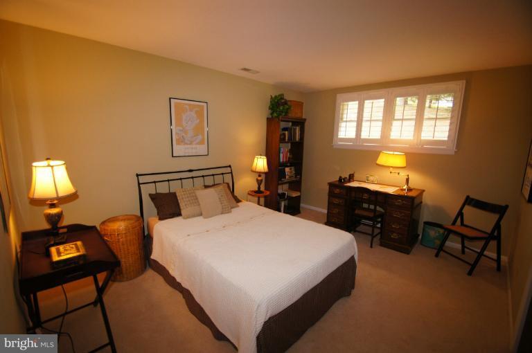 9504 Dundawan Road Nottingham, MD 21236 - Photo 17 of 30 a bedroom with a bed and wooden floor