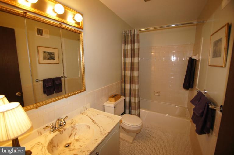 9504 Dundawan Road Nottingham, MD 21236 - Photo 19 of 30 a bathroom with a sink a toilet and shower