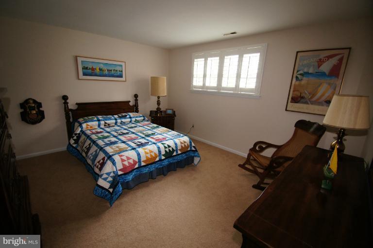 9504 Dundawan Road Nottingham, MD 21236 - Photo 3 of 30 a bedroom with a bed a dresser and paintings