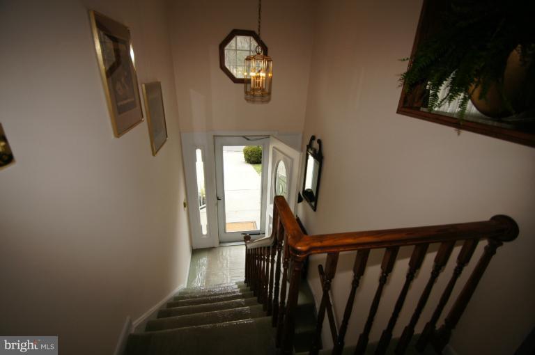 9504 Dundawan Road Nottingham, MD 21236 - Photo 21 of 30 a view of a hallway with wooden floor and staircase